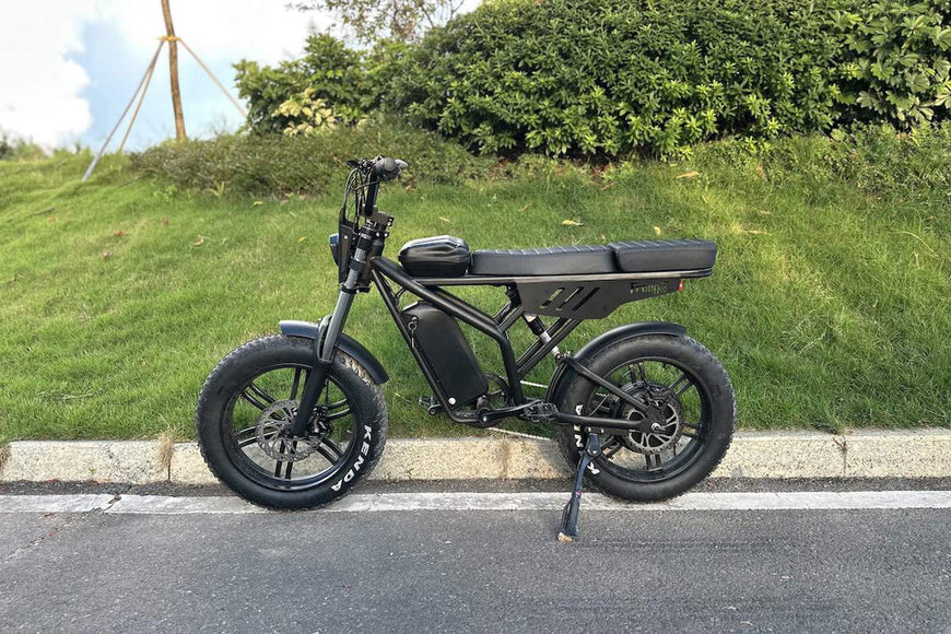Black electric bike parked on a road with grass and bushes in the background. Freego Shotgun F2 Pro Max Prime Fat Tire E-Bike