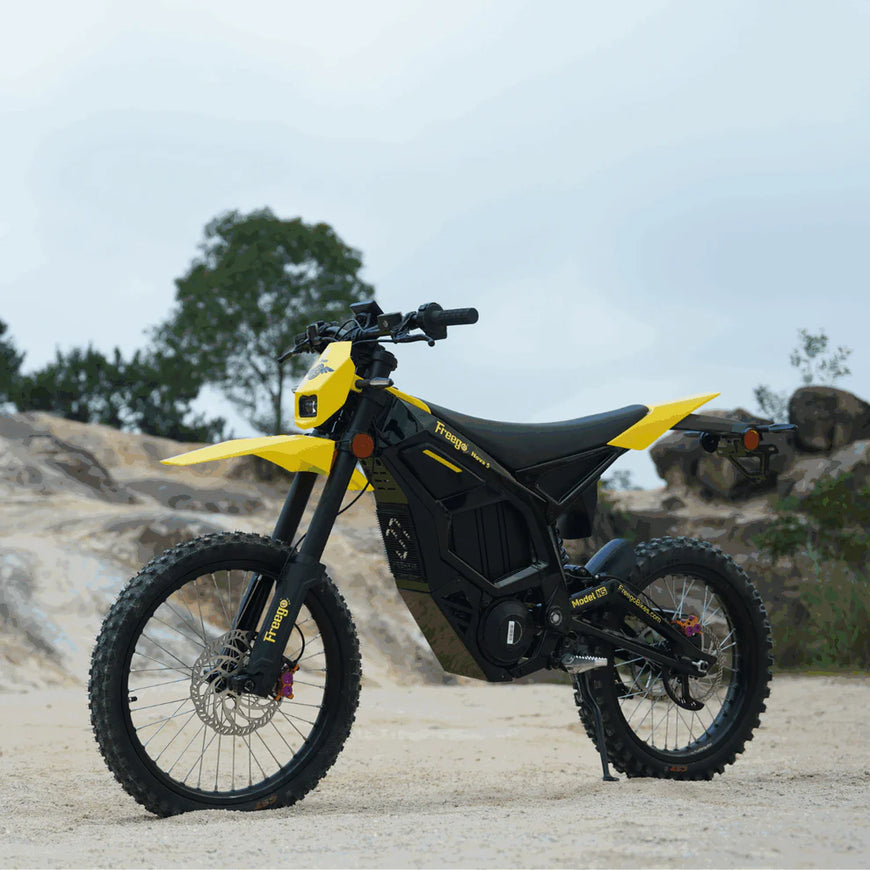 Yellow and black electric bike on a rocky outdoor terrain. Freego Nova 5 Mid-Drive Off-Road Electric Dirt Bike