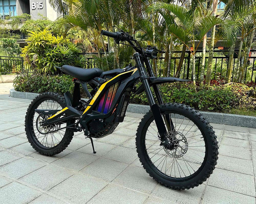 Black electric bike with colorful design on a paved area with greenery in the background. Natkie N1 All-Terrain Electric Motorcycle