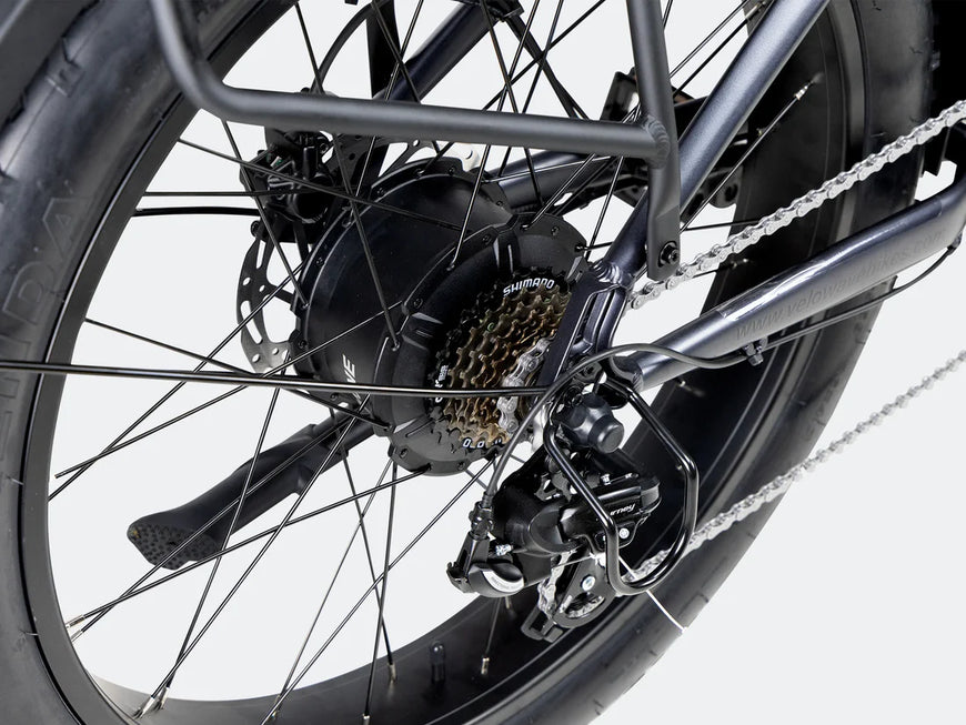 Close-up of a bicycle wheel with gear and chain on a white background. Valowave Ranger 3.0 Fat Tire All-Terrain Electric Bike