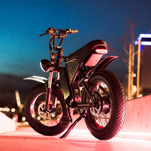 Motorcycle with red lights on a city street at night. Freego S1 Cafe Racer eBike
