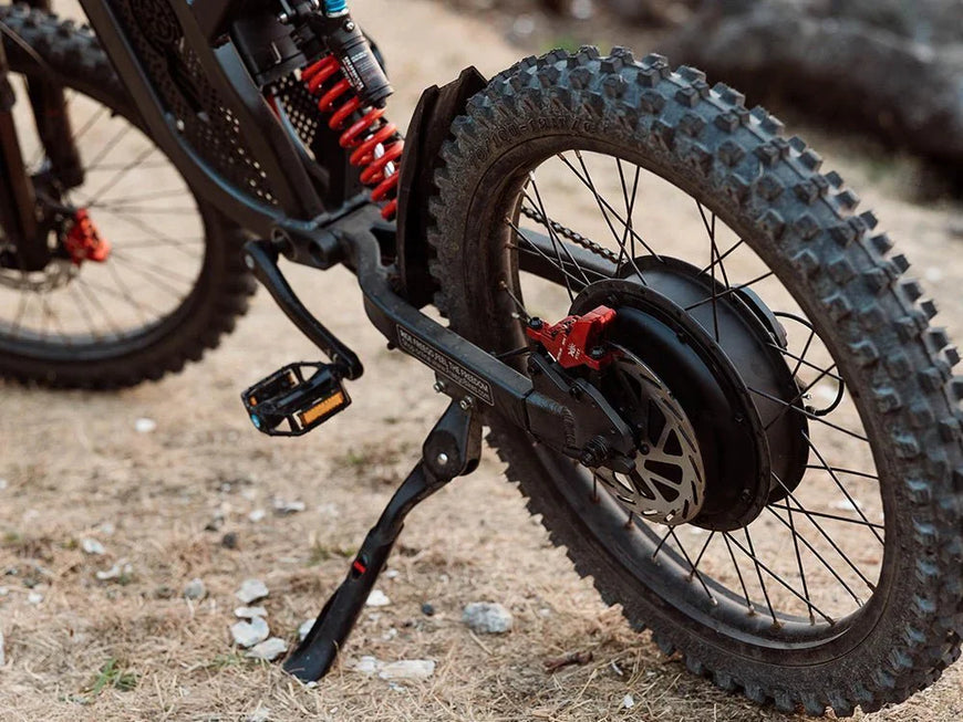 Close-up of a mountain bike with suspension fork on a natural ground surface. Freego X2 Pro All-Terrain Dirt eBike