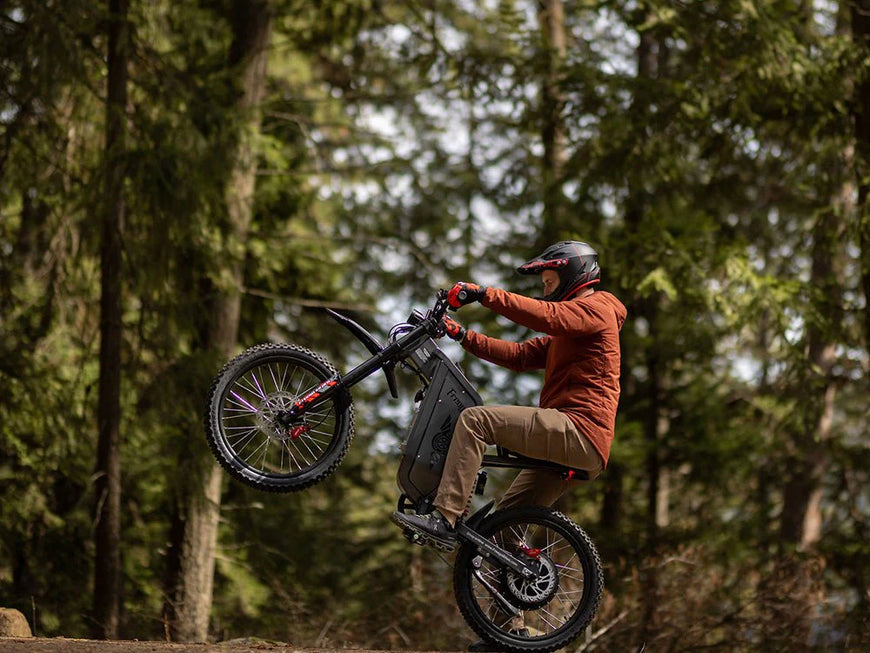 Person riding a mountain bike in a forest. Freego X2 Pro All-Terrain Dirt eBike