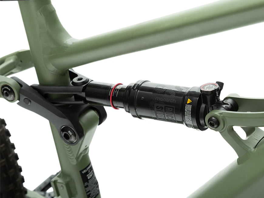 Close-up of a bicycle suspension fork with a green frame on a white background. Valowave Forest XM MTB
