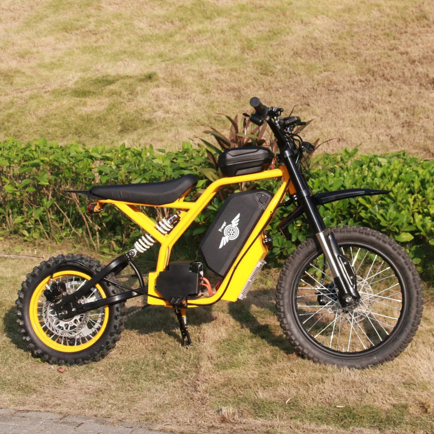 Yellow electric bike on a grassy area with plants in the background. Freego Nova 2 Mid-Drive Youth Electric Dirt Bike