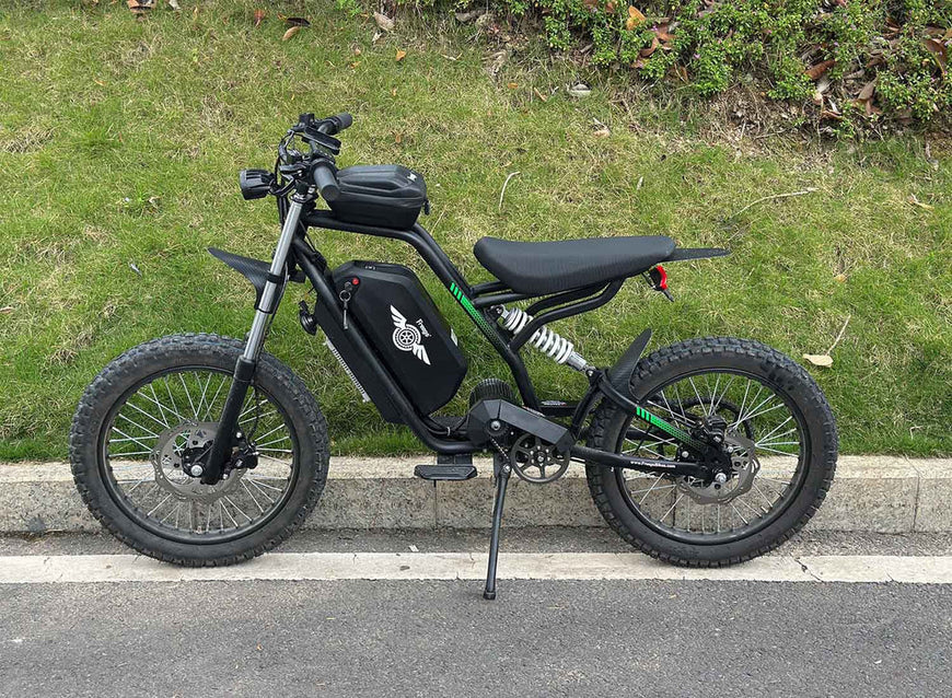 Black electric bike on a road with grass in the background. Freego Nova 3 Mid-Drive All-Terrain Dirt eBike