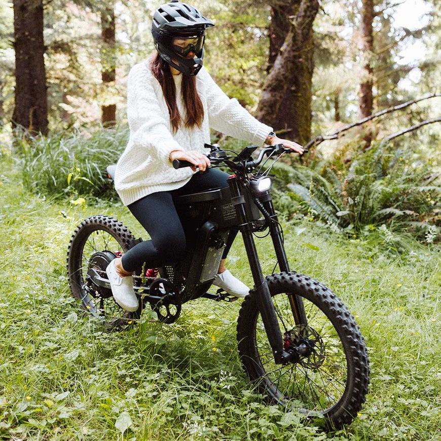 Person riding a mountain bike in a forest. Freego X2 Pro All-Terrain Dirt eBike